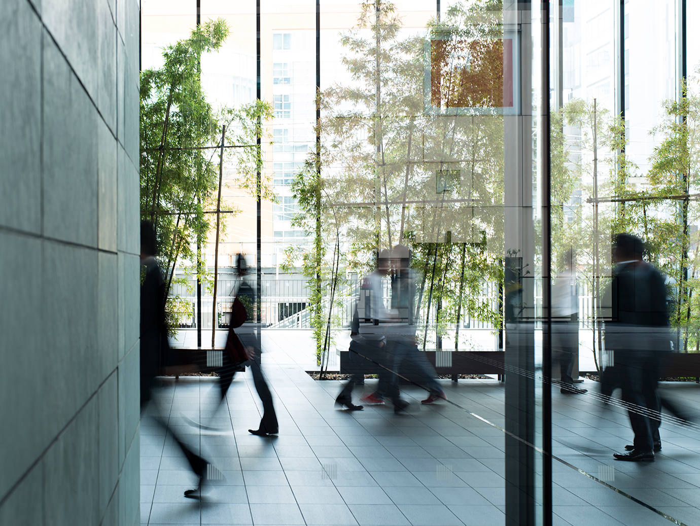 Motion blur shot of people walking in an office lobby