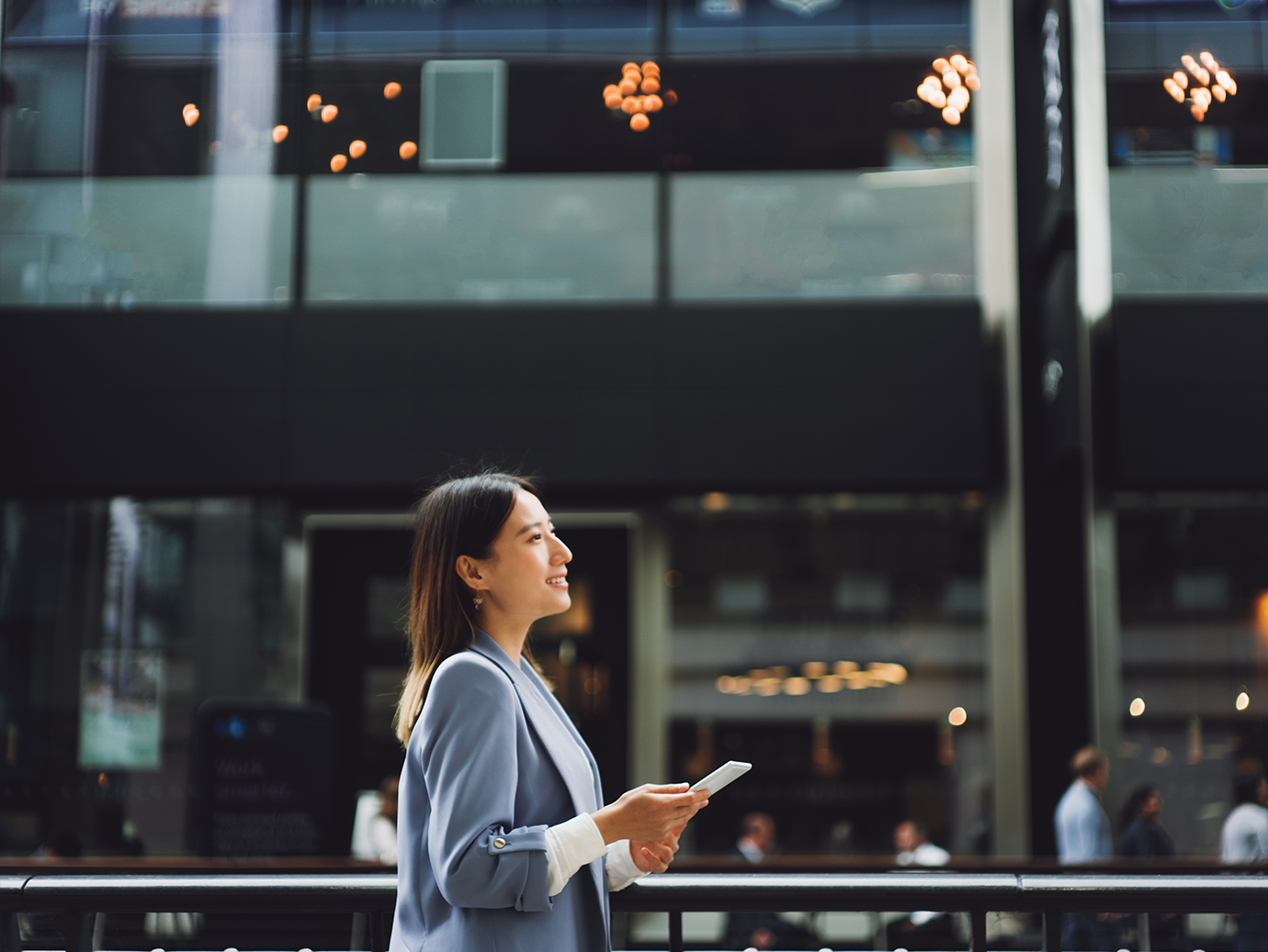 Side view of a woman with a mobile phone in her hand