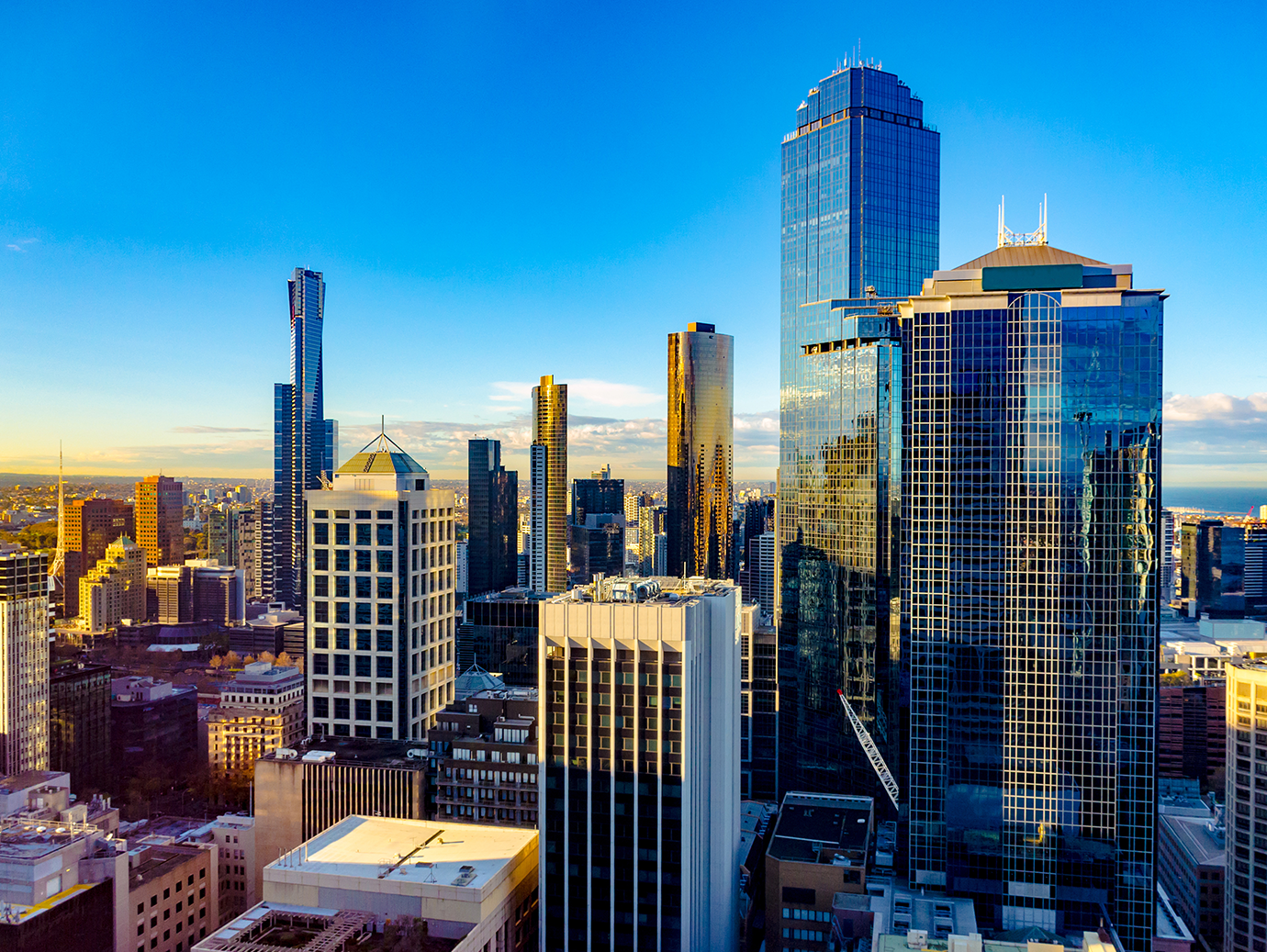 A cityscape of corporate buildings at dawn