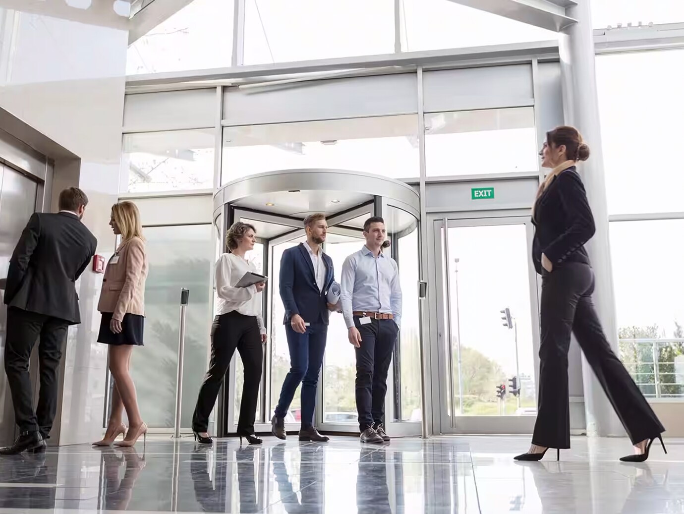 Six people walking in the foyer of a corporate office