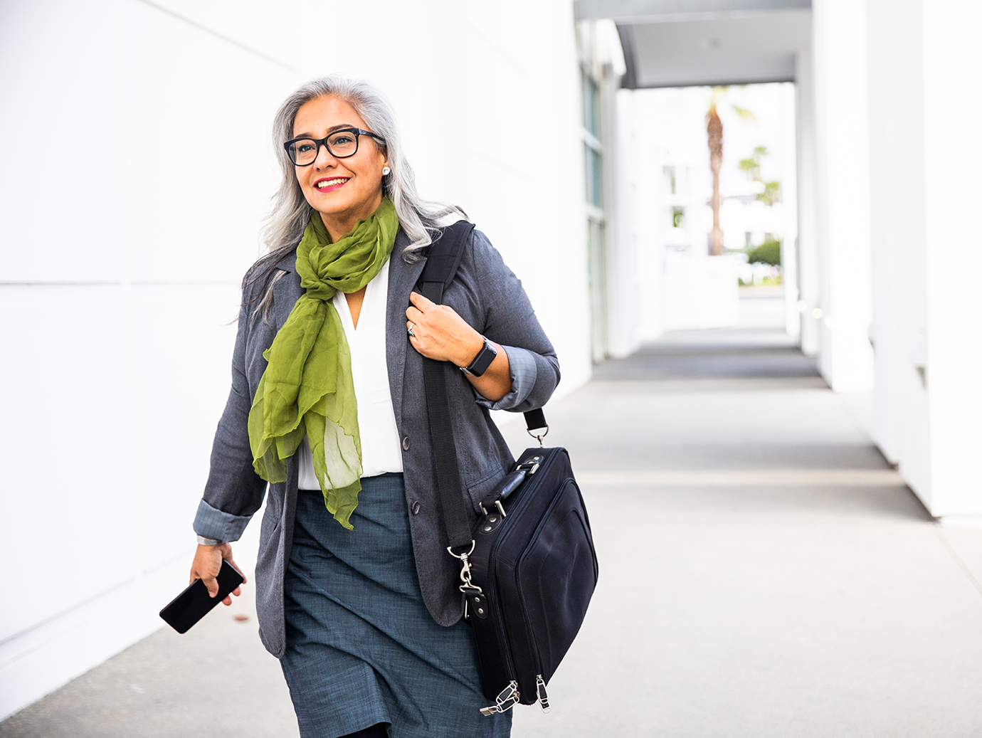 A woman in formal attire walking