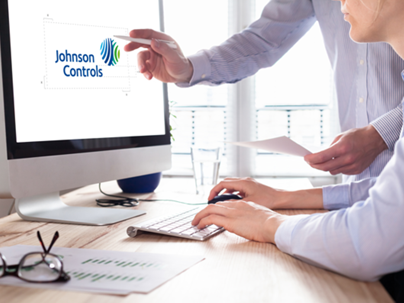 A man sitting in front of an iMac