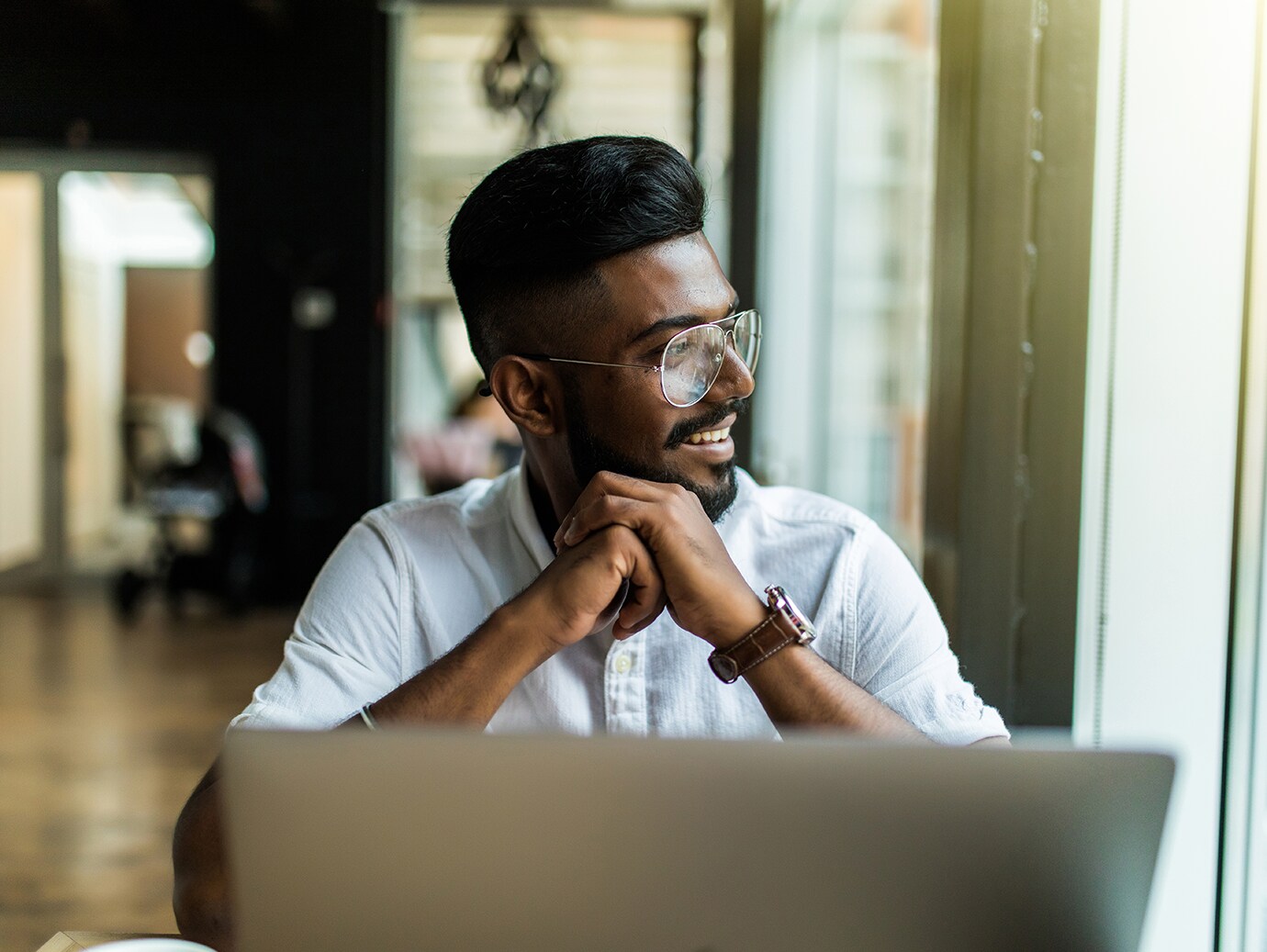 Man sitting at a desk rubbing his hands together