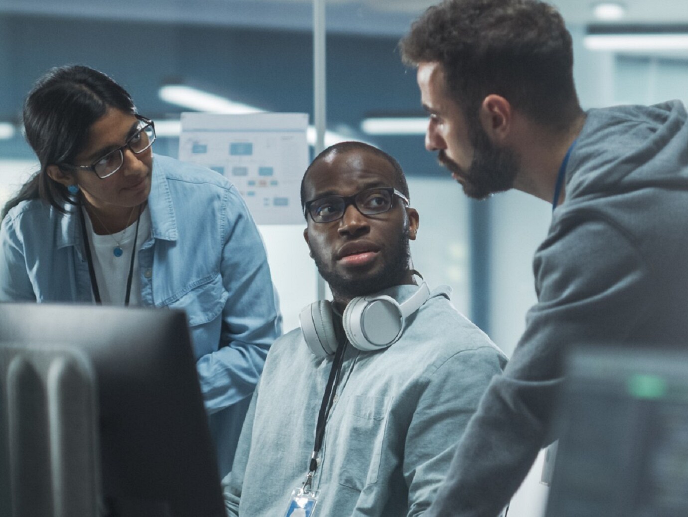 Three people discussing in a conference room