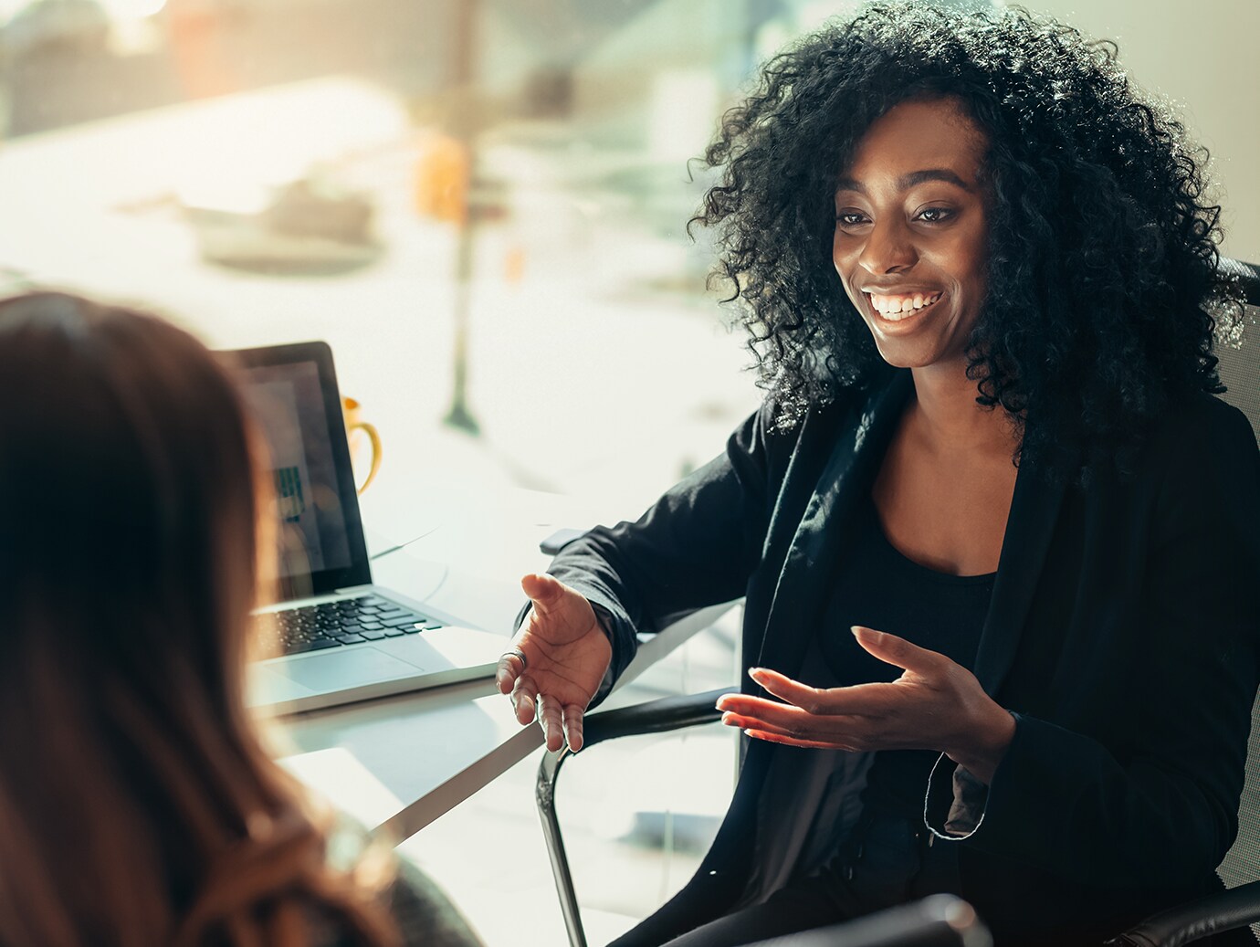 Two colleagues in discussion in an office lobby