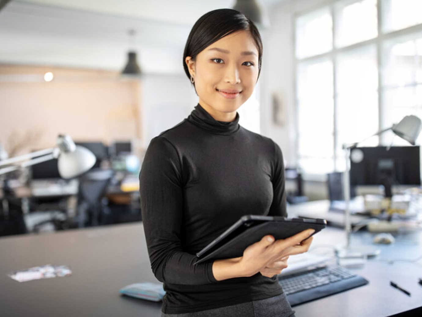Women holding tablet and smiling