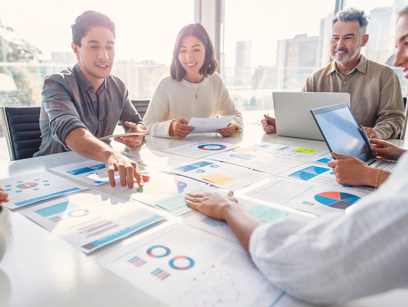 Four colleagues having a discussion around a table
