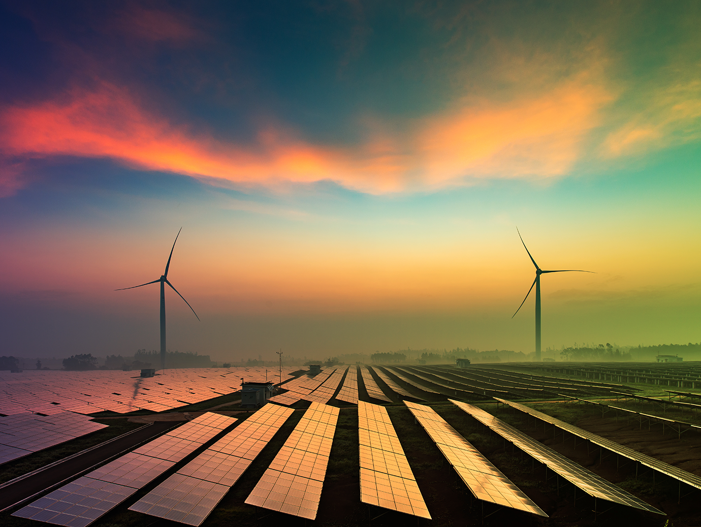 An evening view of the solar farm and windmill