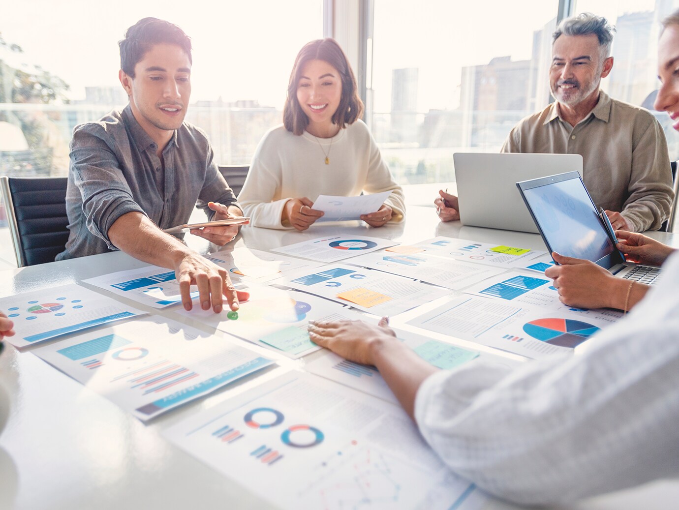 Four colleagues having a discussion around a table