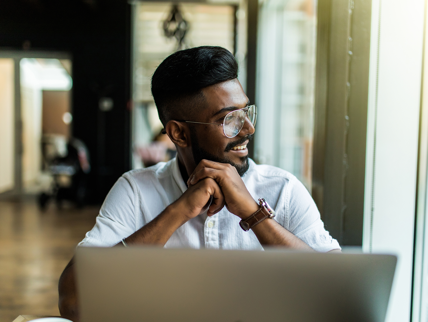 Man sitting at a desk rubbing his hands together